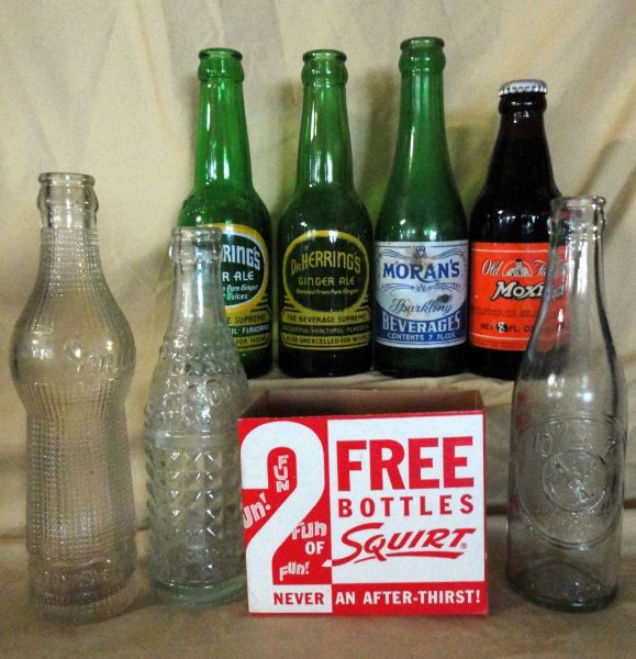 SODA BOTTLE LOT: 7 Vintage Soda Bottles Including: Moran's Sparkling Beverages, 7oz; 2 Dr Herring's Ginger Ale, 6 oz; Old Fashion Moxie, Unopened, 8 oz; 1922 Smile, 6.5 oz; Soda Water, Chero Cola Bott. Co., 6 oz & 2 B