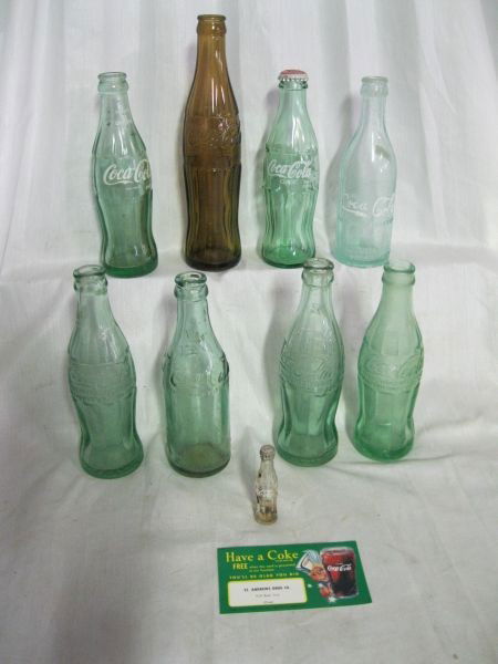 COCA COLA BOTTLES: 9 Vintage Coco Bottles: Tall Brown, Starkville, Miss.; & 7 Green Inc. Dark Green River Junction; RG Co 1 Columbia, S.C.; Quincy, Fla.; Three Pensacola, Fl (2 Embossed Pat..O. Dec.25, 1923 & White Lett