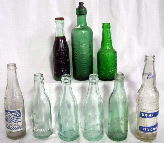 NINE EMBOSSED BOTTLES: Inc. Green “G & C. M Edinburgh Limited” w/Moore Ltd. On Screw Stopper, 6”T; Four Blue/Green “Bay Bottling Works,” (1-Panama City, Fla. & 3-Apalachicola, Fla.), 7.5”T; Clear Barq's w/Blue &