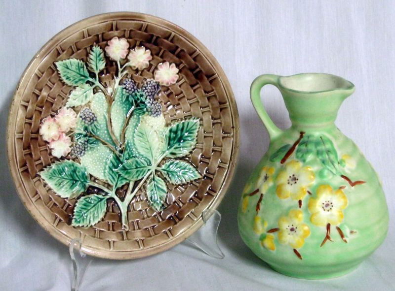 COLORFUL POTTERY LOT: 2 Pieces of Colorful Pottery Including: 6.5”H Green Pitcher w/Dogwood Motif, Marked M; 8.5” Decorative Plate Brown Basket Weave with Berry & Floral Design, Sponged Back, Unmarked.