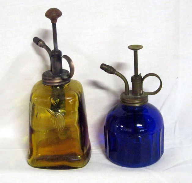 VINTAGE SPRAY BOTTLES: Two Vintage Spray Bottles Including: 7.75”T Gold Glass w/Embossed Leaf on 2 Sides, 6.5”T Cobalt Blue w/Ribbed Panel Pattern, Both Have Metal Screw on Caps.