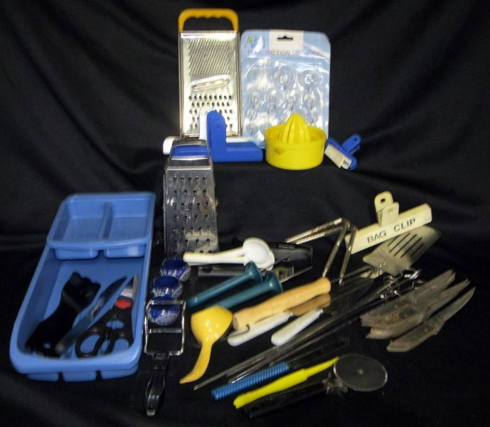 KITCHEN LOT: Lot Includes Not Limited to: 2 Tier Blue Utensil Holder; 6 Kitchen Clips; 2 Carolina Oyster Knives; Left Handed Scissors; 22 Knives; Pizza Cutter, Zester; Juicer, 2 Graters & Skewers.