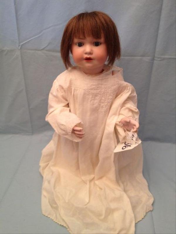 Armand Marseille A&M #971 German Bisque Doll: A socket head doll with sleep eye open mouth teeth and tongue on a five piece composition baby body. Measurements: 19". Condition: Very Good with bisque flake above left ear no hairlines noted as the 