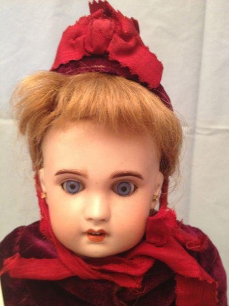 French Bebe Jumeau Bisque Head Doll: A bisque head doll marked "Jumeau S.F.B.J. Paris 6" with replaced set eyes original mohair wig open mouth with 4 molded teeth pierced ears and composition jointed body. The body is marked "Bebe Jumeau