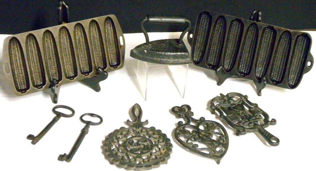 Cast Iron Lot: Cast Iron Lot Including #5 Sad Iron, 2 Cornbread Pans, 2 Keys & 3 Trivets.