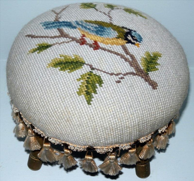 DIMINUTIVE NEEDLEPOINT FOOTSTOOL: Diminutive Needlepoint Footstool, Depicting Bird On Tree Limb, Trimmed w/Hammered Hail Heads And Tassels, 3 Wooden Legs, , Gifted In, 8.5"D x 6.75"T.