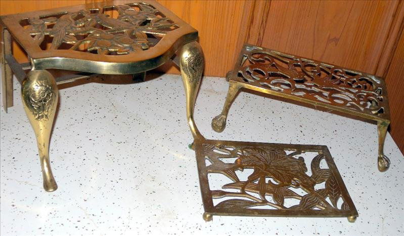THREE BRASS FIREPLACE TRIVETS: Three Brass Fireplace Trivets, From .5"T To 6.25"T.