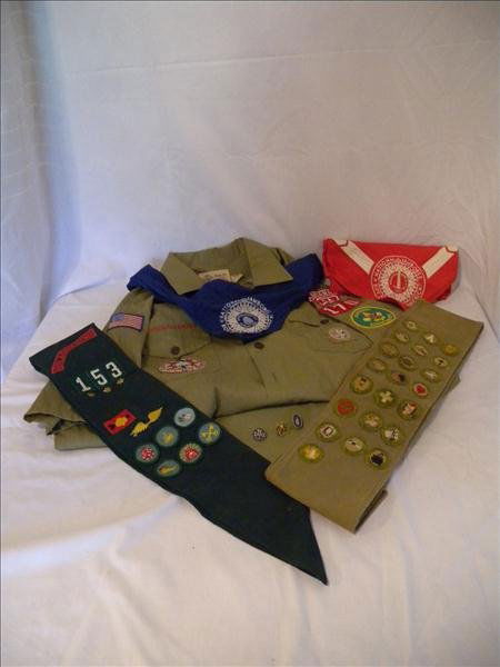 SCOUT UNIFORMS: SCOUT UNIFORMS Including complete Boy Scout Leader Uniform w/shirt, pants, belt, sash and 2 jamboree scarves (1935 &1937). Sash includes 22 badges. Girl Scout sash w/6 merit badges, fly over wings, pa