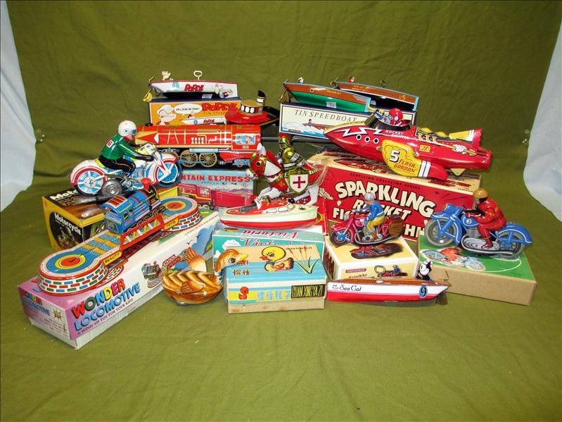 14 Tin Toys: 14 Tin Toys, Inc. Wind-Ups and Steam Driven Boat, 3 Motorcycles, 6 Boats, One Knight, 2 Trains, Older Deck and Flash Gordon's Rocket Fighter Ship.