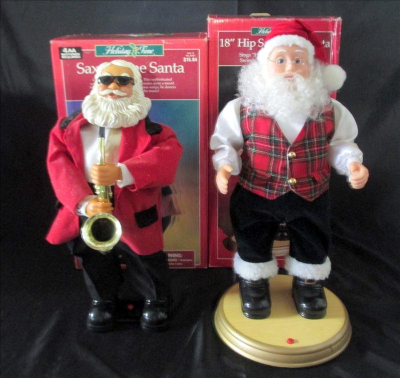 2 Holiday Santas: 2 Holiday Santas, Inc. 18" Hip Swinging Santa (Sings "Here Comes Santa Claus") and Saxophone Santa, In Orig. Boxes.