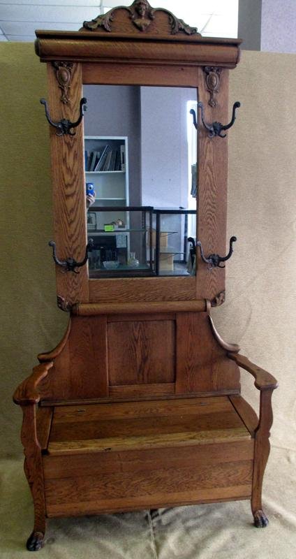 Oak Hall Tree: Decorative Figural Top, Classical Decorations on Sides, 4 Large Metal Hooks, Storage Seat, Animal Front Seat & Mirrored Back, 38.5 x 16 x 80"T.