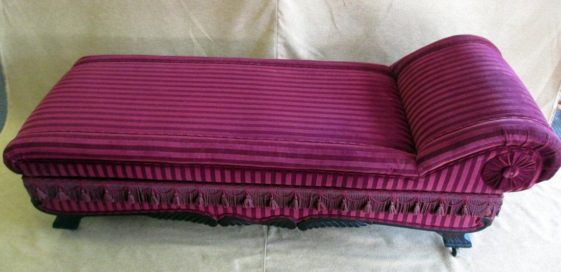 Victorian Fainting Couch: Upholstered Striped Burgundy Velvet Couch Opening to Double Bed, Carved Apron, Wooden Casters and Draping Fringe, 76 x 27 x 26"T.