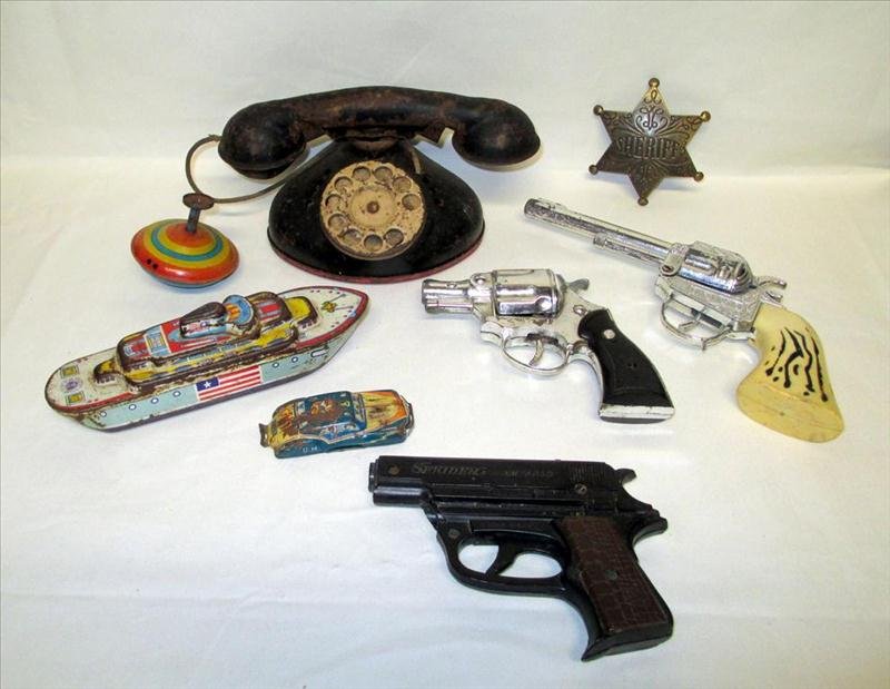 Vintage Toys: Vintage Toys, Including Metal Rotary Phone, Plastic and Metal Guns, Metal Sheriff's Badge, Metal SS American Ship, Top and Auto.
