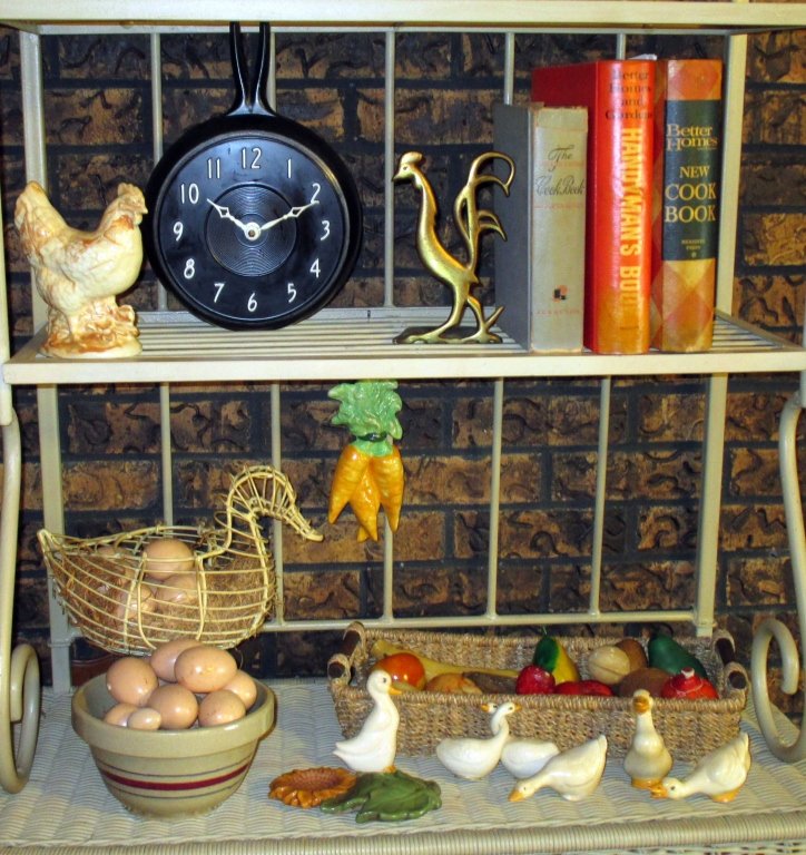 Vintage Kitchen Plus Lot: Including egg basket & bowl w/ceramic eggs (some broken), over 15 pcs. fruit (ceramic & alabaster), Cookbooks, Alabama Clay rooster, 8.5" D frying pan clock.