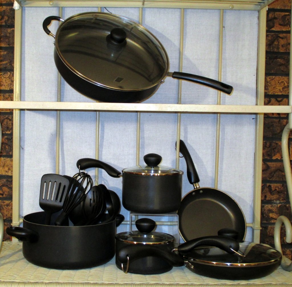 Farberware Cookware: 8 pcs. Farberware inc. 2 pots, 2 pans, dutch oven, 3 lids, unmarked pan & lid and 8 pc. utensil set by Prestige. Largest skiller is 12"Dia.