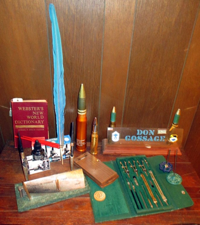 Men's Writing Lot Plus: Inc. 4 bottles of ink, 2 calligraphy pens, 21.5" long quill, desk pen set, desk name w/2 shells, 2 vintage paper holders, 13 pc. drafting set, two military shells (tallest 11") and more.