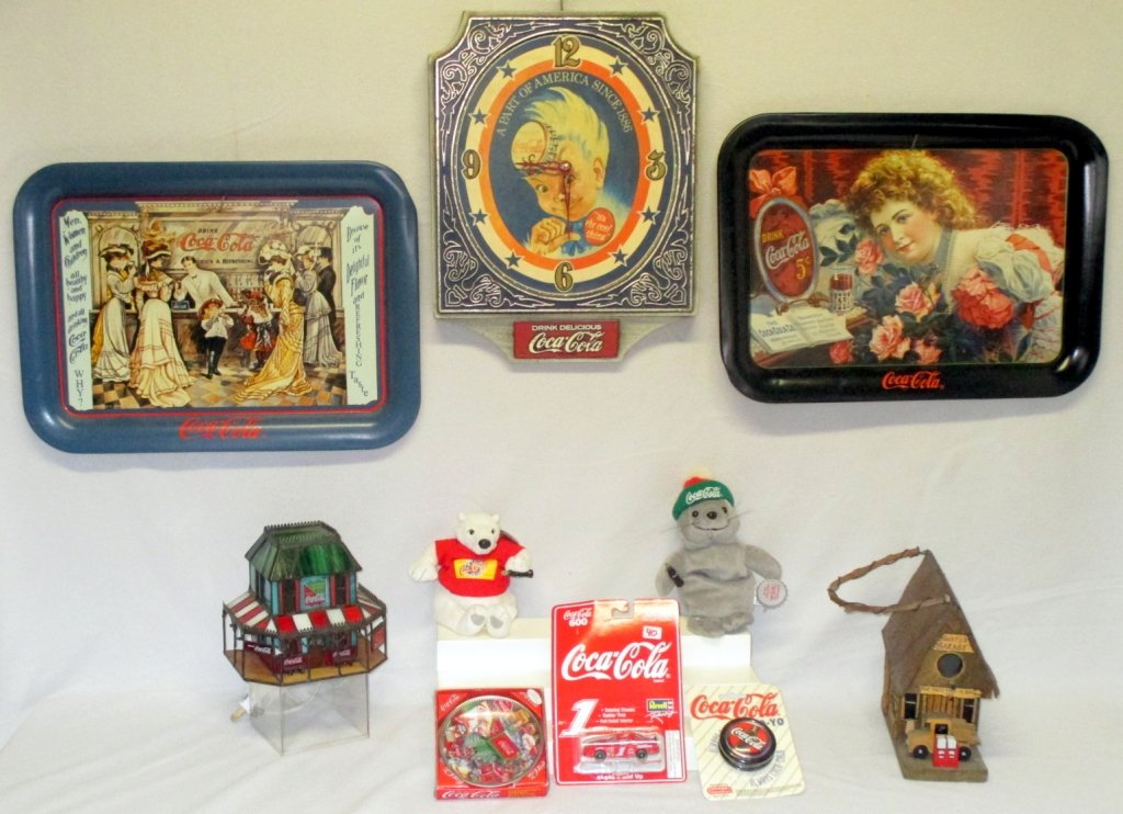 Coca Cola Collectibles: 2 Coke trays, clock, bird cage, mini plates in orig. package, Revell Racing Car in orig. package, bean bag bear & seal w/orig. tags, Duncan Yo-Yo in orig. package and stain glass light.