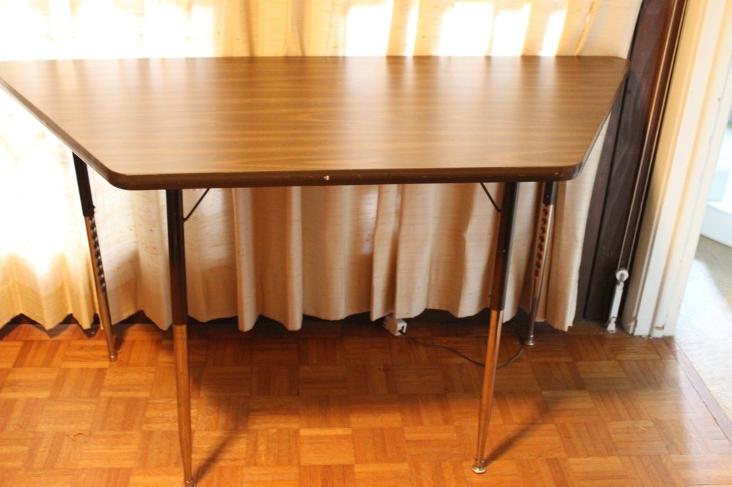 Shaped Adjustable Work Table: 57" x 26" x 23"-30" tall.