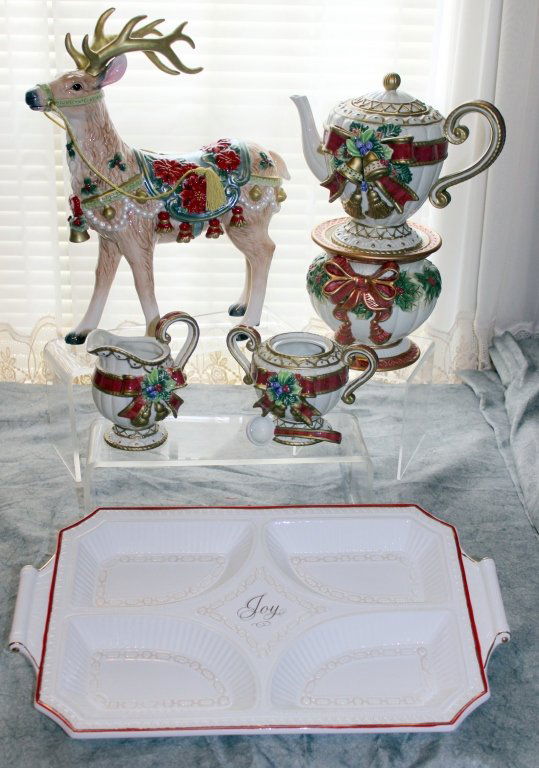 Fitz & Floyd Plus Christmas Lot: Fitz & Floyd reindeer & teapot on stand, creamer and sugar w/spoon (no lid); and a divided "Joy" serving dish.