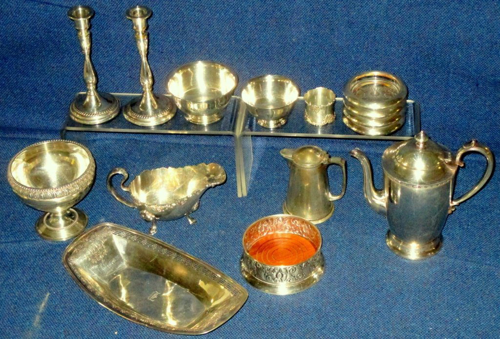Silver Plate Hollowware: Including teapot, engraved pedestal, Sheffield syrup, wine coaster, pair candlesticks, gravy boat, coasters, pierced bread tray, napkins ring and two Revere style bowls.