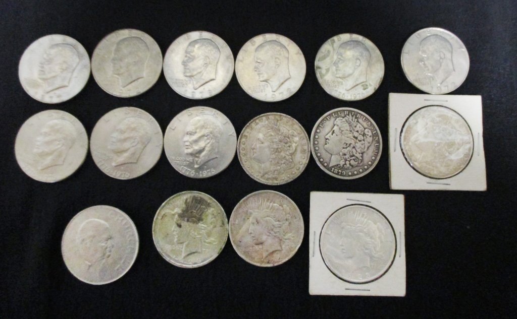 Morgan, Peace & Eisenhower Dollars Plus Crown: 3 Morgan Silver Dollars (1879, 1888 & 1921), 3 Peace Dollars (1922 & two 1923), 9 Eisenhower Dollars (three 1972, four 1976, 1977 &1978) plus English Crown.