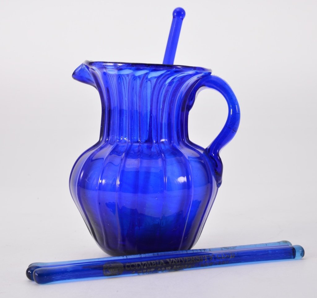 Blue Glass Swizzle Sticks And Small Pitcher: Ribbed 4.5" tall pitcher, swizzles 6" long, 2 Ladies Lounge Columbia Variety Club NY., 1 Louis Sherry 300 Park Avenue NY., 1 Hotel New Western. Expected wear.