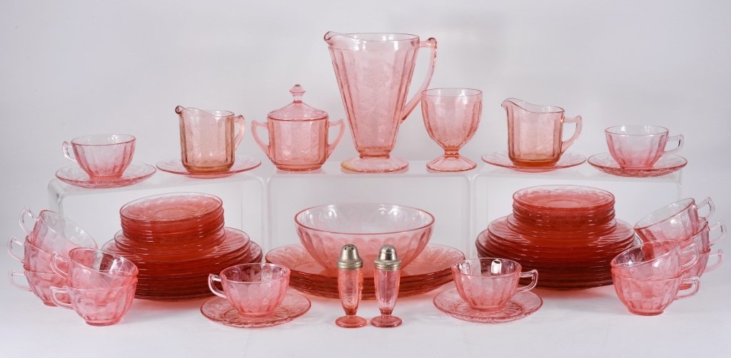 Pink Floral/Poinsettia Dinnerware: Over 50 pieces including pitcher, footed salt and pepper, cream and sugar, 14 cups and saucers, plates, plus. Jeannette Glass 1931-35. Expected wear.