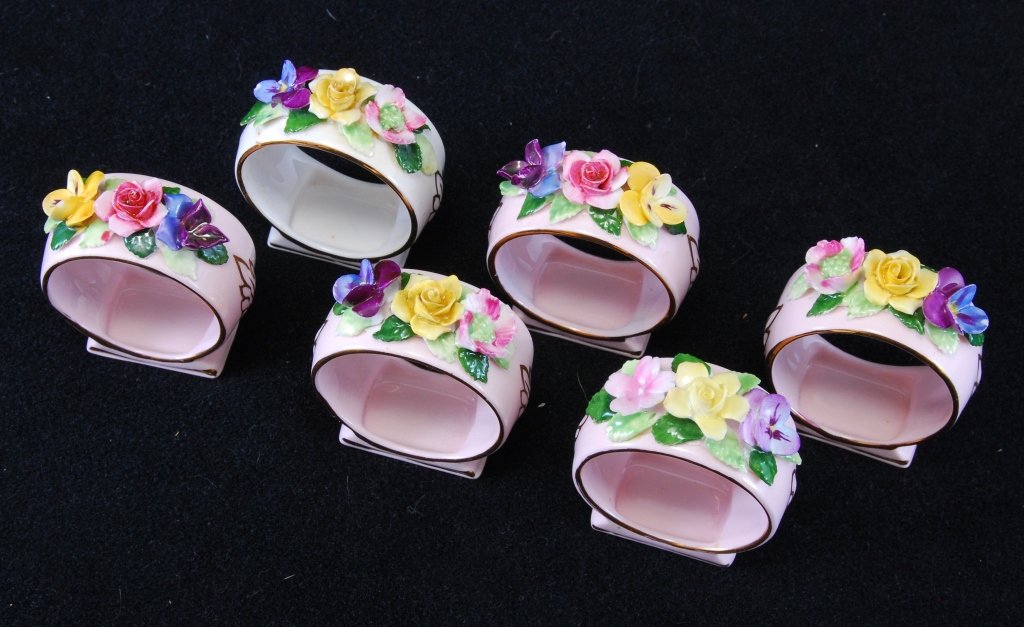 Six Royal Adderley Porcelain Floral Napkin Rings: Five pink, one white, trimmed in gold.