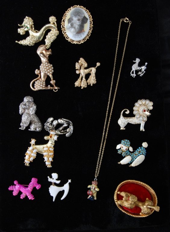 Poodle Jewelry Plus: Eleven pins, including Trifari & Jerrys, clip, necklace and figurine in bed.