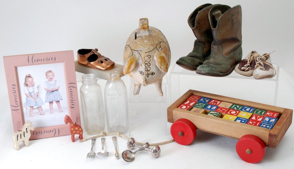 Vintage Children's Lot: Shoes & boots (marked 1957 on one sole), silverware, bottles, sterling silver rattle and toothbrush, bronze shoe and wagon of blocks.