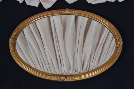Vintage Wooden Gold Painted Oval Mirror: Applied decoration top, bottom and sides; 28.5" tall x 20.5" wide.