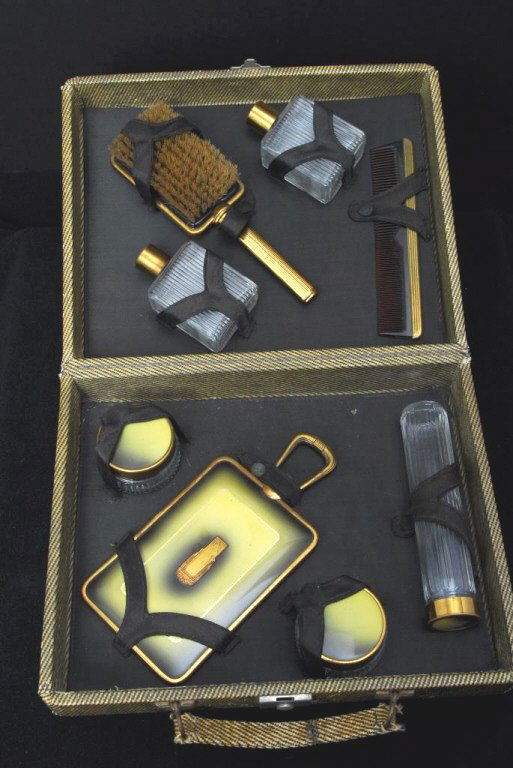 Art Deco Traveling Toiletries in Fitted Case: Including bottles, jars, hand mirror, comb and brush, case 12" wide x 10" deep x 3,5" tall.