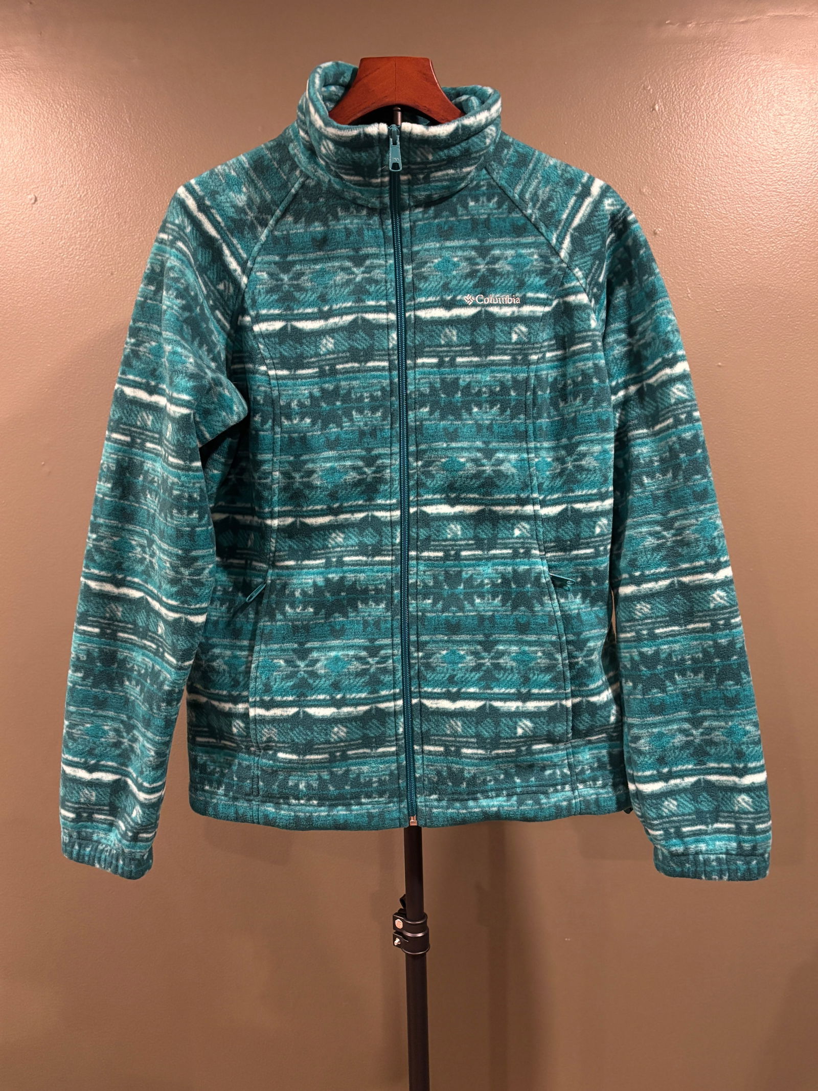 Women's Columbia Sportswear Teal Geometric Fleece Jacket, Size Large: Columbia Sportswear full-zip fleece jacket featuring jewel-toned teals and greens. Soft, mid-weight polyester fleece with zippered pockets and adjustable drawcord waist. B: 22" L: 26"