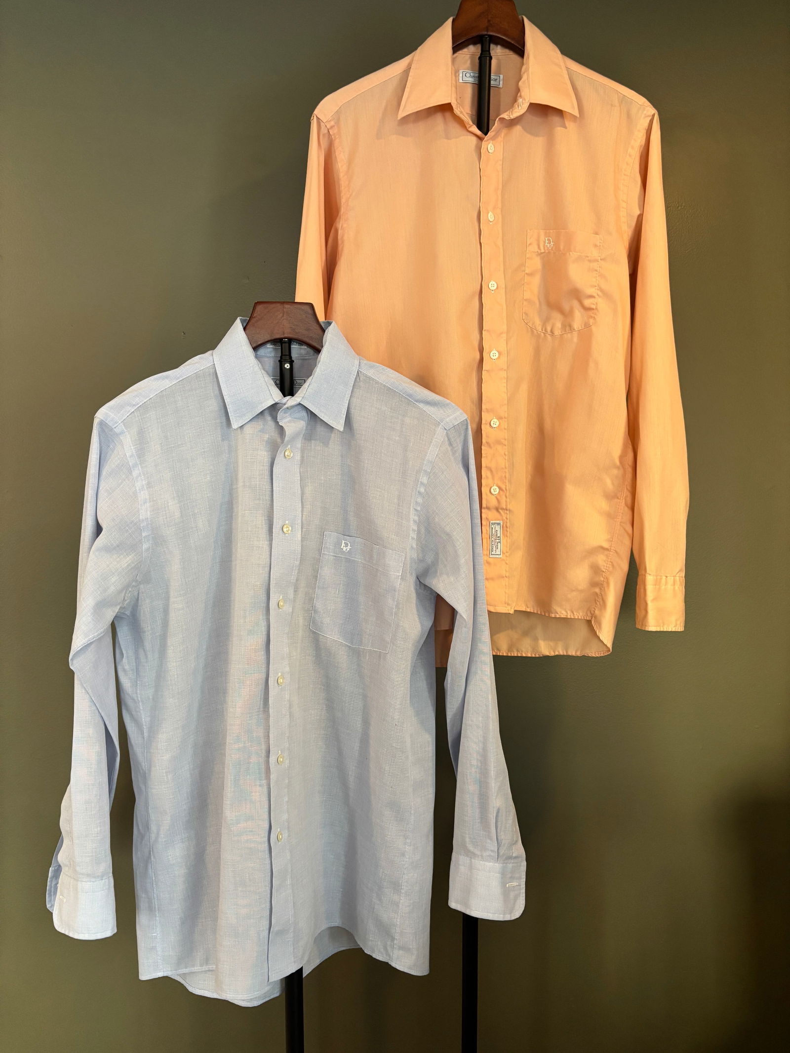 Pair of Christian Dior Monsieur Sheer Dress Shirts, Blue and Peach: Pair of men's sheer dress shirts by Christian Dior Monsieur, presented together. Includes one light blue shirt and one peach-toned shirt, both crafted from a lightweight, semi-transparent woven fabric