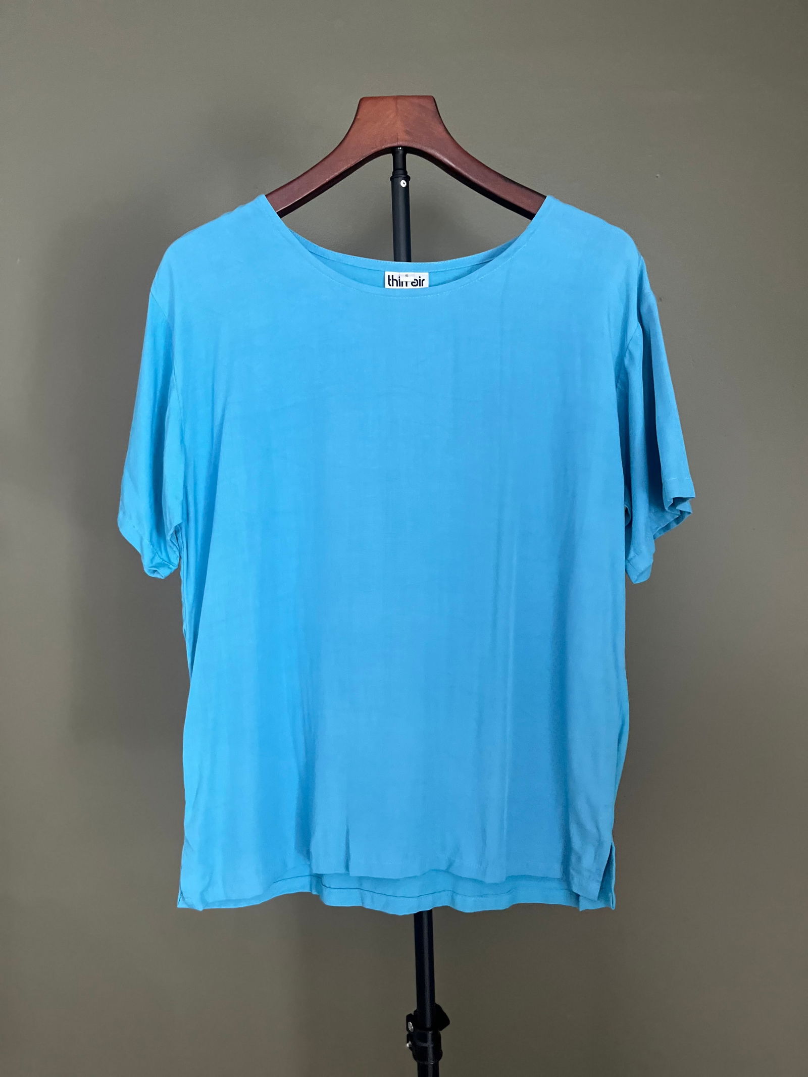 Thin Air Turquoise Blue Rayon Short-Sleeve Top, Size S: Women's short-sleeve top by Thin Air in a bright turquoise blue rayon. Lightweight and fluid with a wide round neckline, relaxed silhouette, and straight hem. Made in Indonesia. An easy, minimalist pi