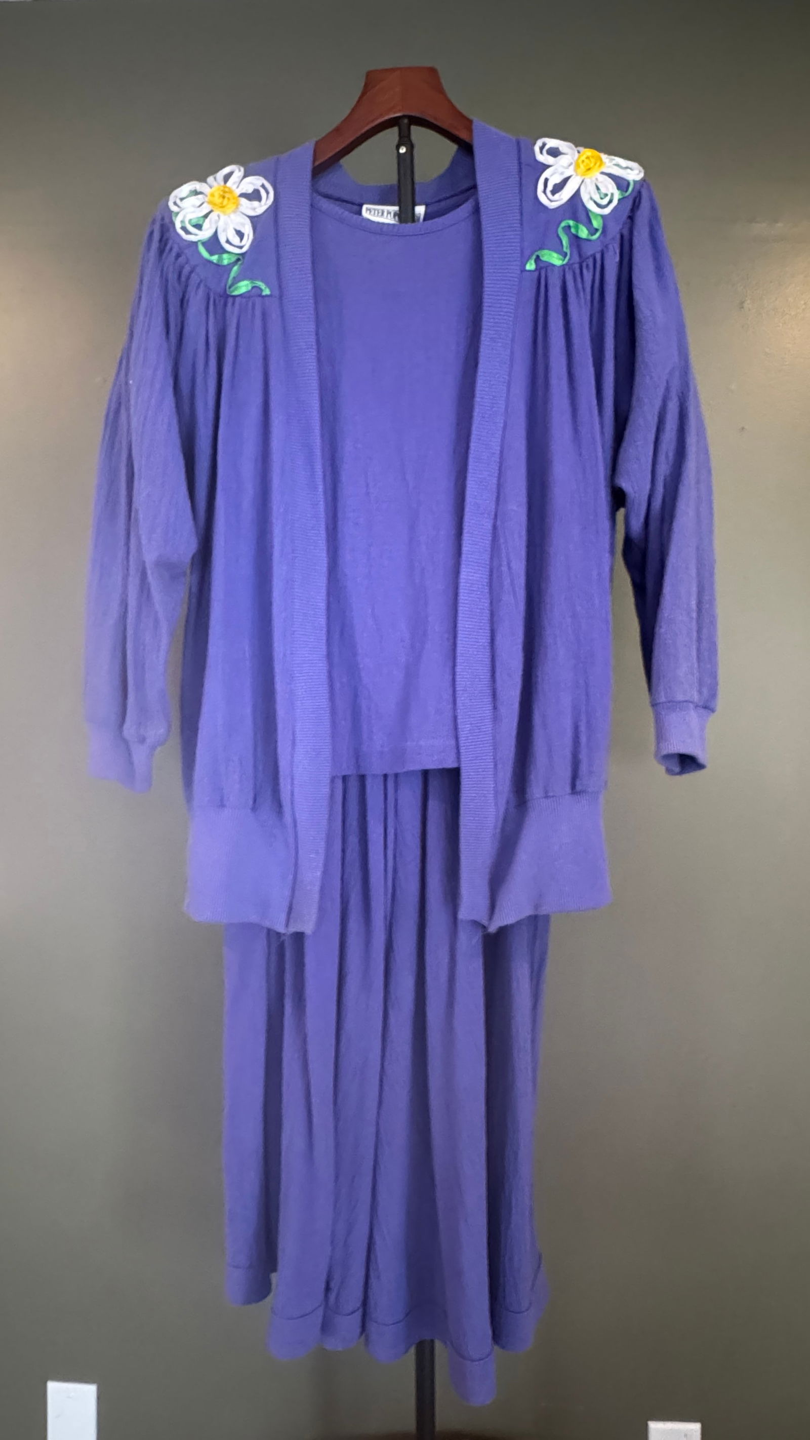 Peter Popovich Embroidered Cotton Shirt, Skirts & Cardigan Group, USA, Size Medium and Large: A charming vintage two-piece by Peter Popovich, featuring a softly textured purple cotton dress paired with a matching open-front cardigan. Both pieces are accented with delicate hand-embroidered flor