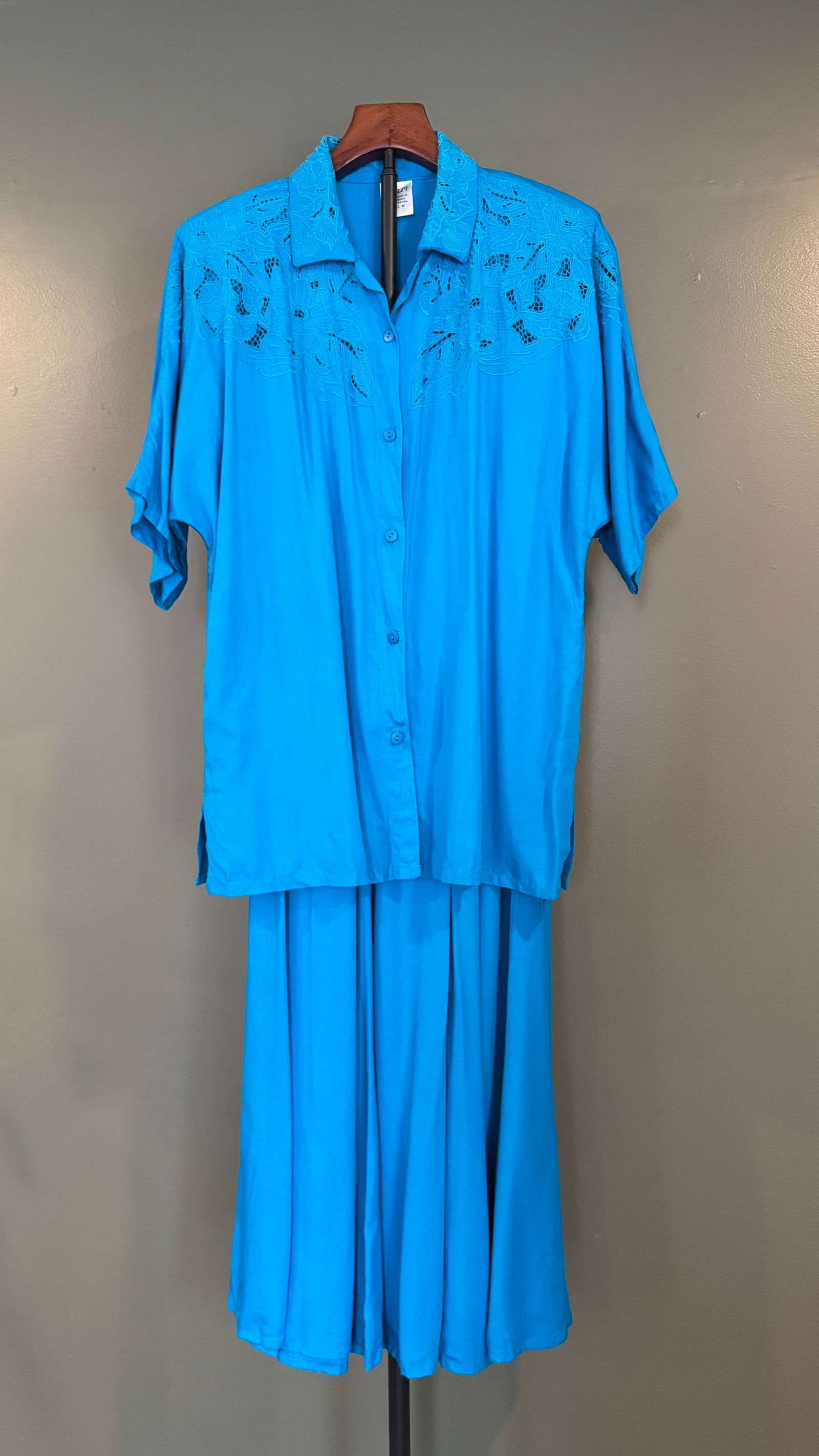 Kulit Hand-Embroidered Rayon Shirt & Skirts Ensemble, Indonesia,: Handmade Kulit two-piece ensemble in vibrant turquoise rayon, featuring a short-sleeve button-front shirt with intricate floral embroidery across the shoulders and a coordinating flowing skirt. Labele