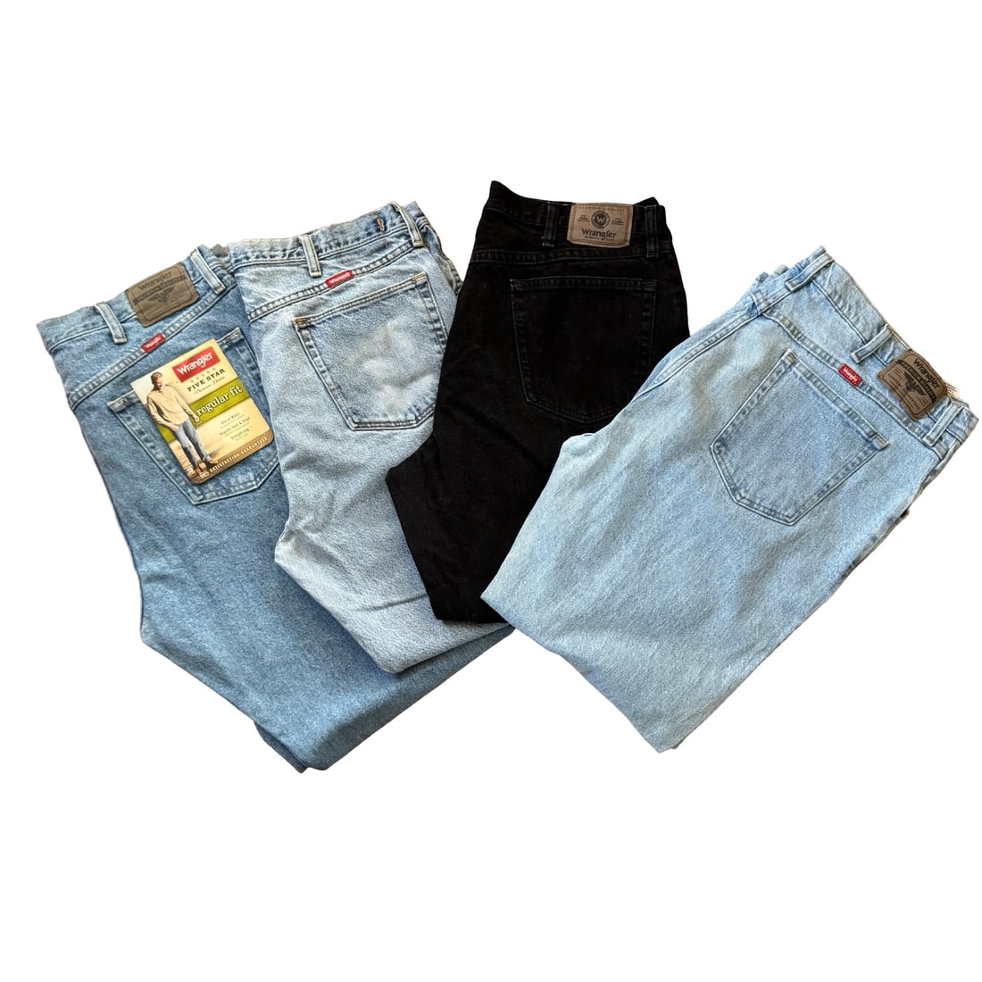 Group of Four Vintage Wrangler Denim Jeans, Assorted Washes & Sizes: A curated bundle of vintage Wrangler denim jeans, featuring classic five-pocket styling in a mix of light blue, medium blue, and black washes. Timeless American workwear silhouettes with natural wear