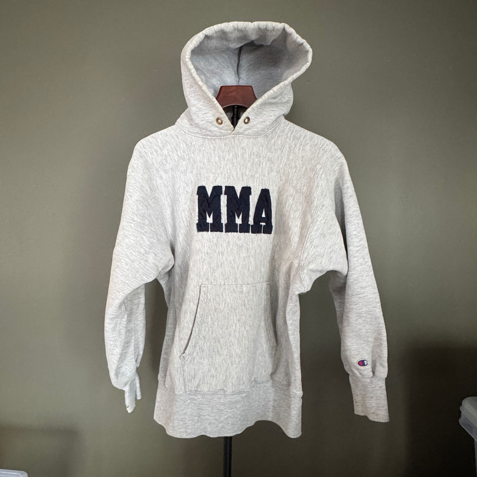 Champion Reverse Weave "MMA" Hooded Sweatshirt, Made in USA: Classic Champion Reverse Weave hoodie featuring bold appliquÃ© "MMA" lettering at chest. Heavyweight gray fleece with kangaroo pocket and traditional Reverse Weave construction. Made i