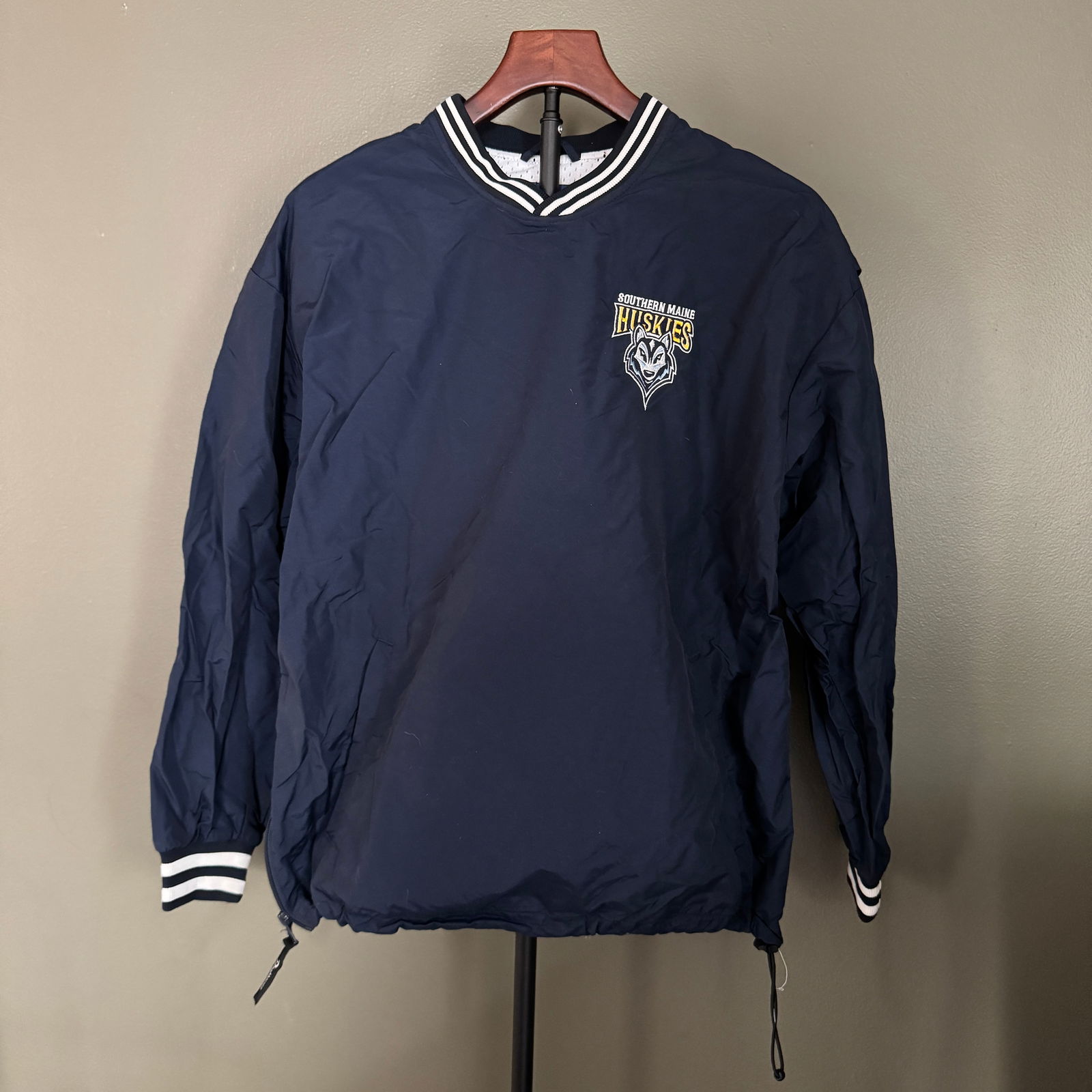 Southern Maine Huskies Pullover Warm-Up Jacket, Boathouse Sports, size s: A navy pullover athletic jacket featuring the embroidered Southern Maine Huskies logo at the chest. Produced by Boathouse Sports, this lightweight performance-style jacket offers classic sideline appe