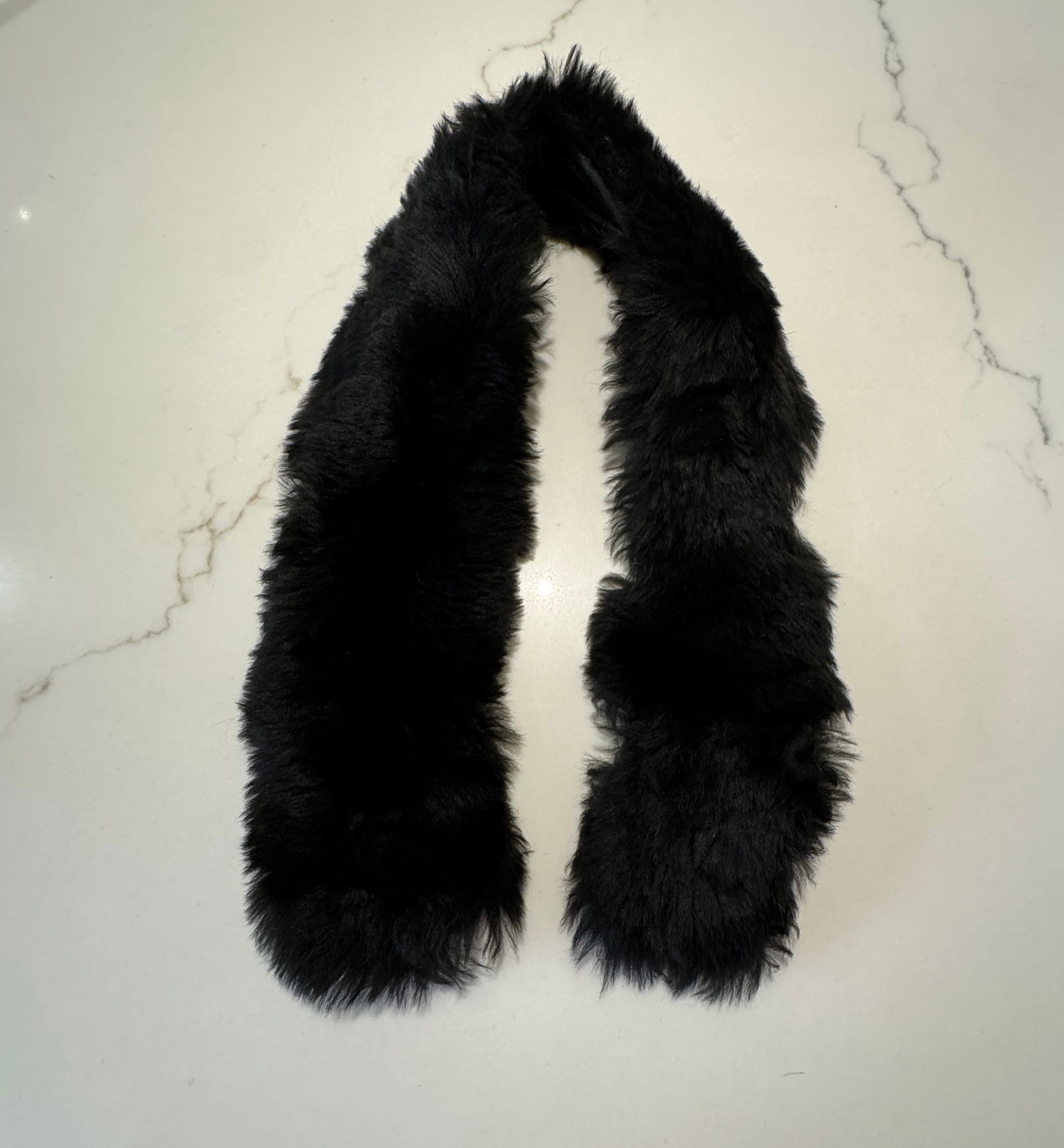 Vintage Black Fur Collar with Hook Closure: A classic vintage black fur collar featuring a plush, elongated form with fabric backing and metal hook closures at the ends. Designed to drape elegantly along the neckline, offering timeless sophisti
