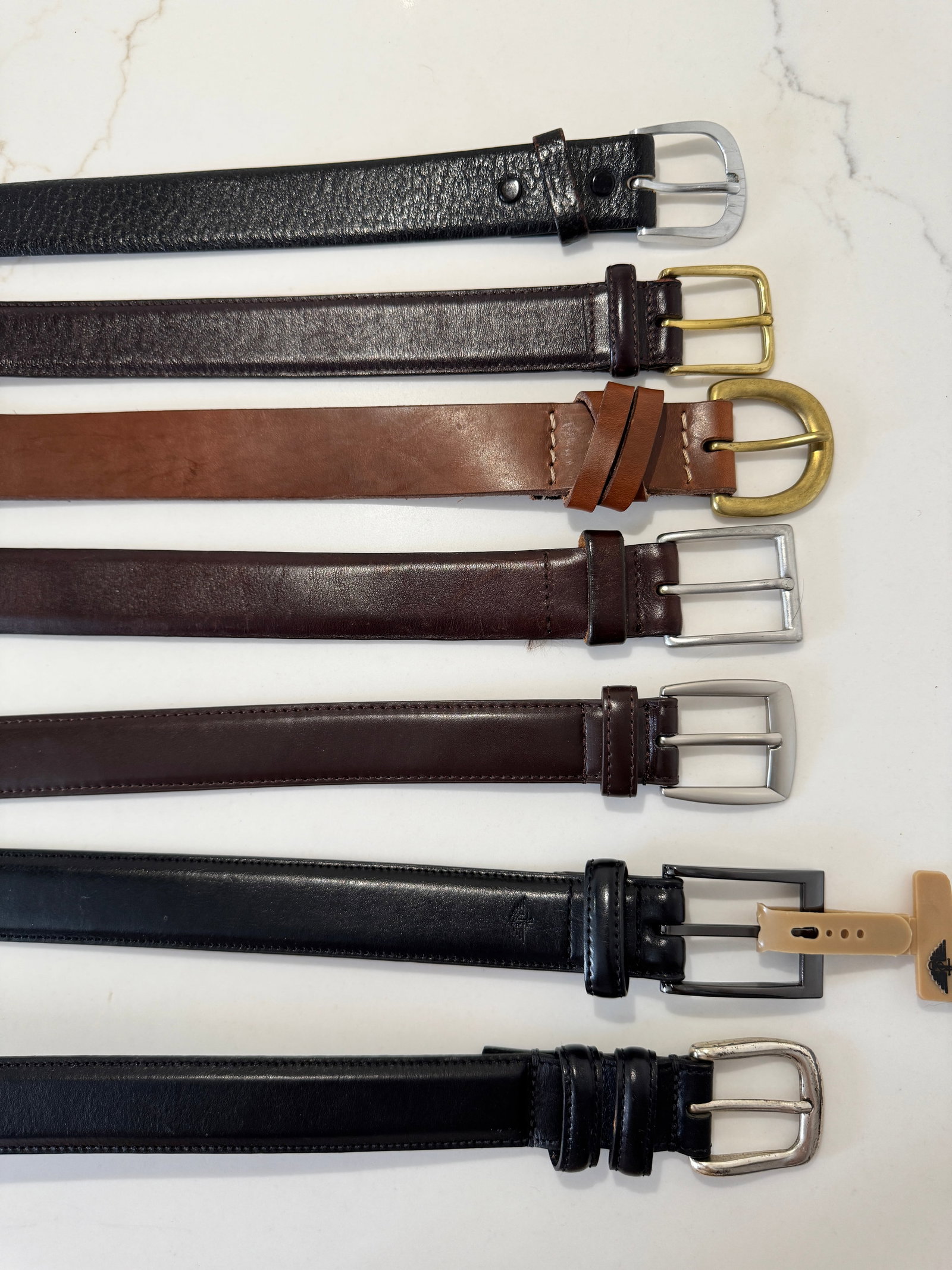 Group of Men's Leather Belts Including Orvis, Dockers & Eddie Bauer: Group of seven men's leather belts in assorted brown and black tones, featuring both brass-tone and silver-tone buckles. Includes examples marked Orvis (Horween leather), Dockers, Eddie Bauer, Jos. A.