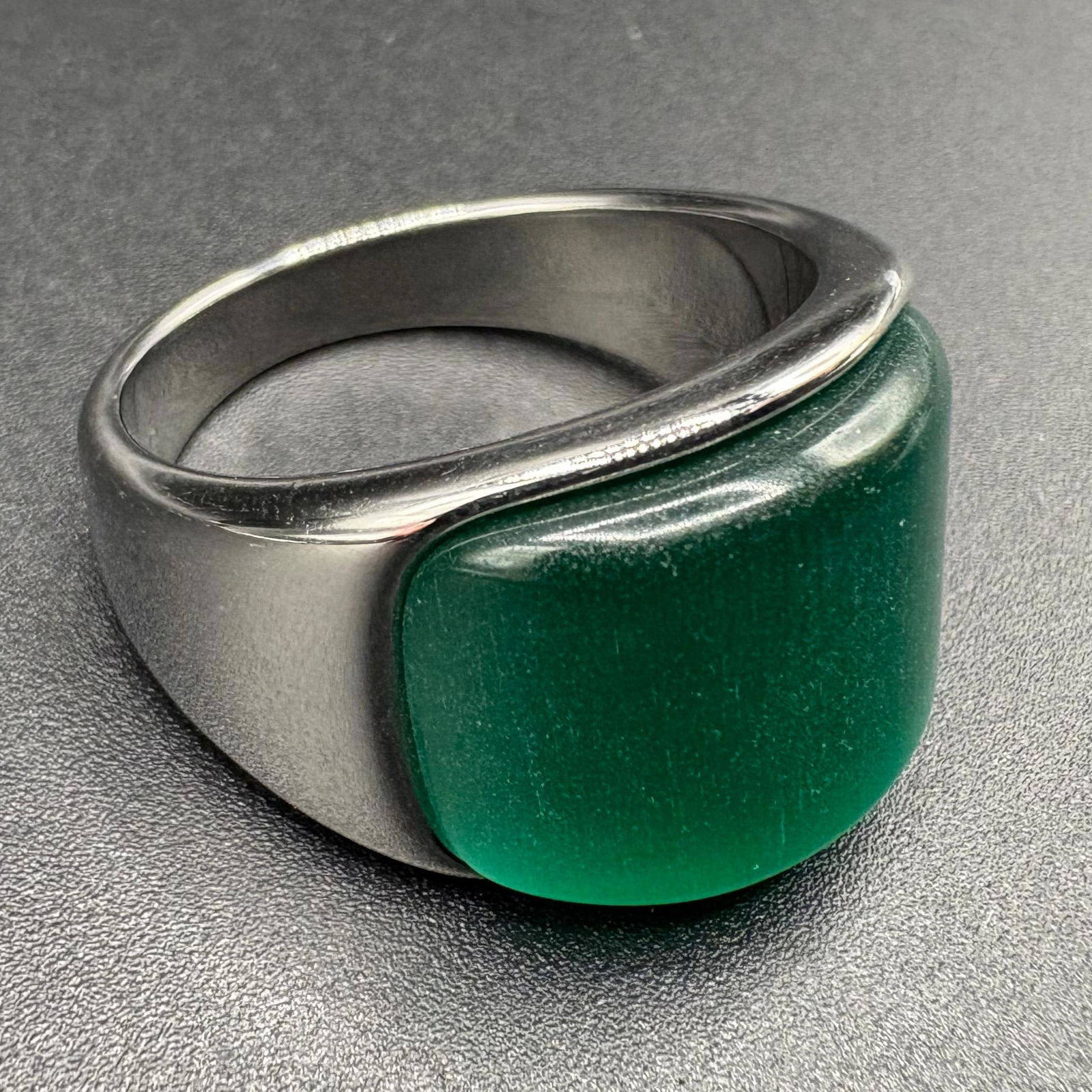 Vintage Floral Engraved K Gold Signet Ring: This vintage statement ring is crafted in 18K gold plated metal and features a classic rectangular face. The center is adorned with a smooth teal opal cabochon, showcasing traditional craftsmanship wi