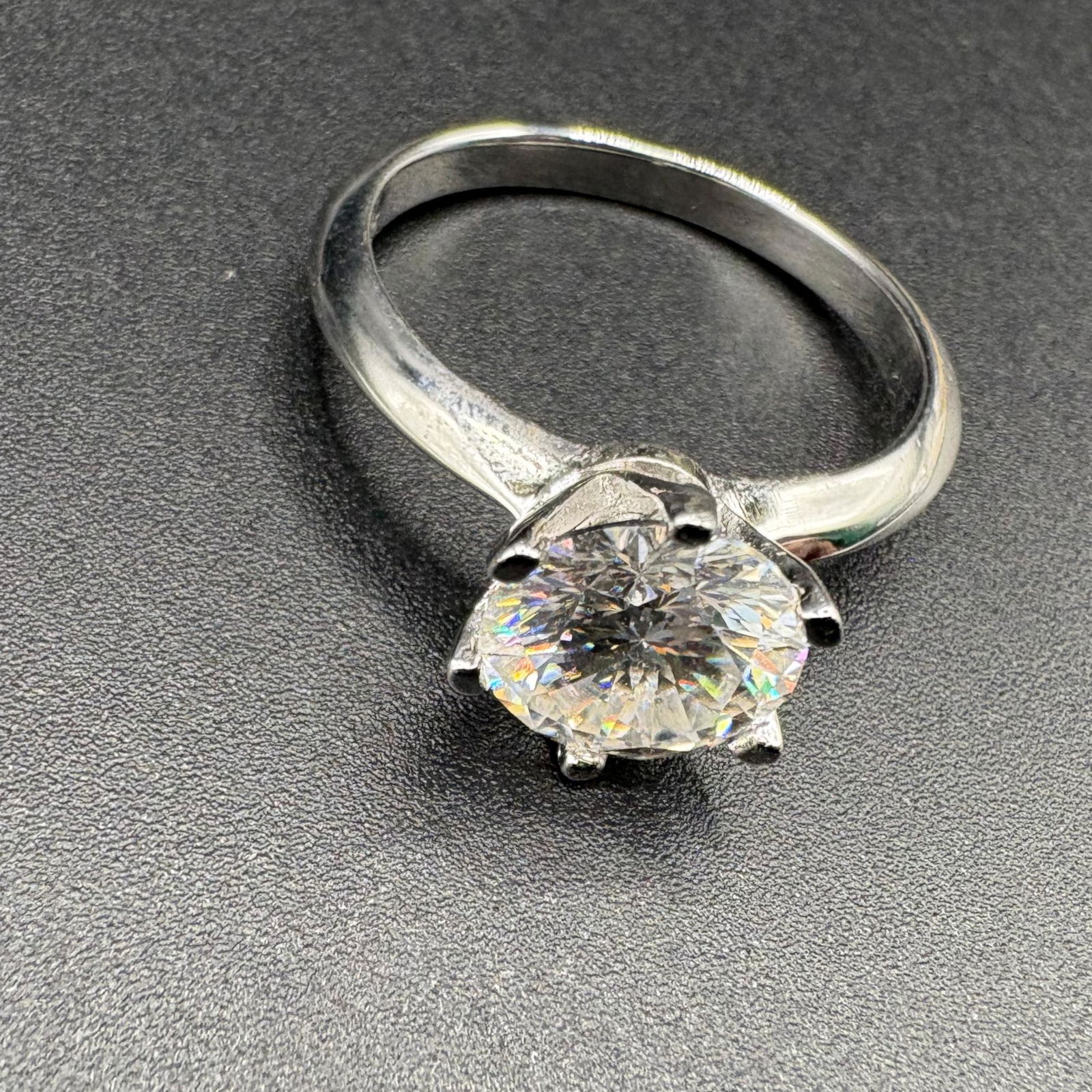 Classic 2CT Moissanite Solitaire S925 White Gold Plated Ring: This elegant solitaire ring is expertly crafted in S925 sterling silver, plated with white gold for a brilliant, high-luster finish. At its heart sits a stunning 2-carat Moissanite gemstone, held secu