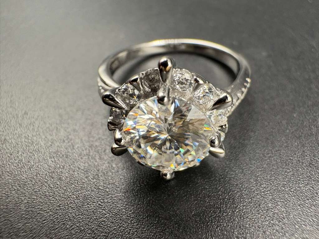 1CT Moissanite Solitaire Ring - GRA Certified: This elegant auction features a 1-carat Moissanite ring, offering diamond-like brilliance and durability. Crafted from S925 Sterling Silver with a premium White Gold plating, it provides a high-end lo