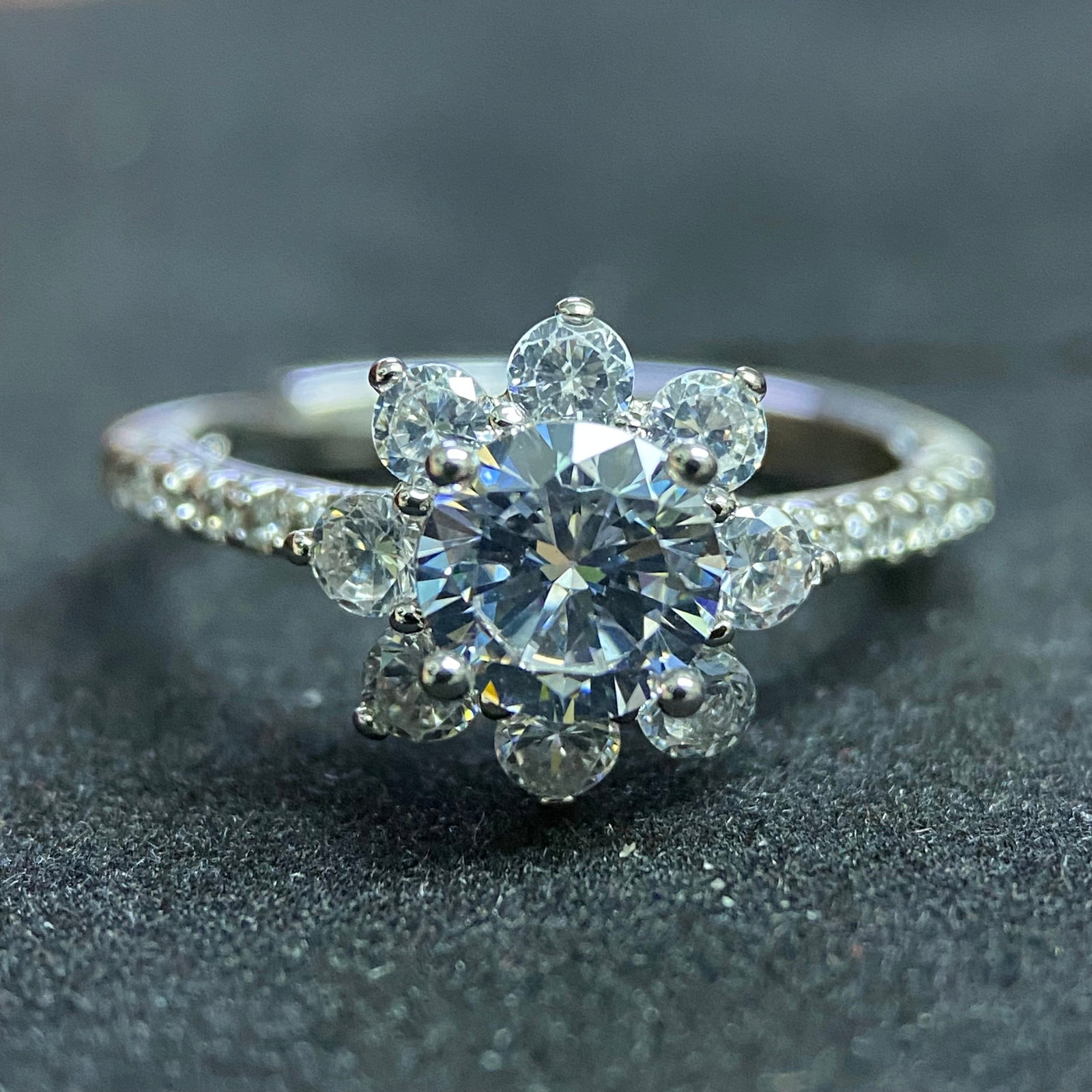 Classic Moissanite Solitaire Ring with Six-Prong Setting: A refined and elegant solitaire ring featuring a brilliant round-cut moissanite center stone. The gem is held securely by a classic six-prong setting on a slender, polished silver-tone band, designed