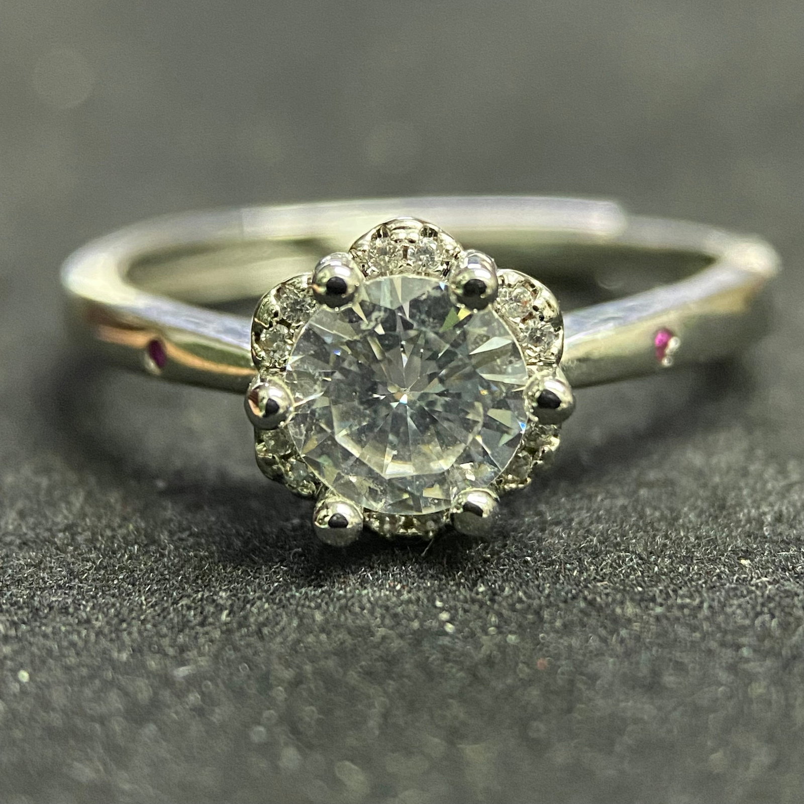 Classic Brilliant-Cut Moissanite Solitaire Ring: A timeless solitaire ring featuring a high-set round brilliant-cut moissanite stone. The gemstone is held by a traditional six-prong mounting on a sleek, polished silver-tone band, designed for maximu
