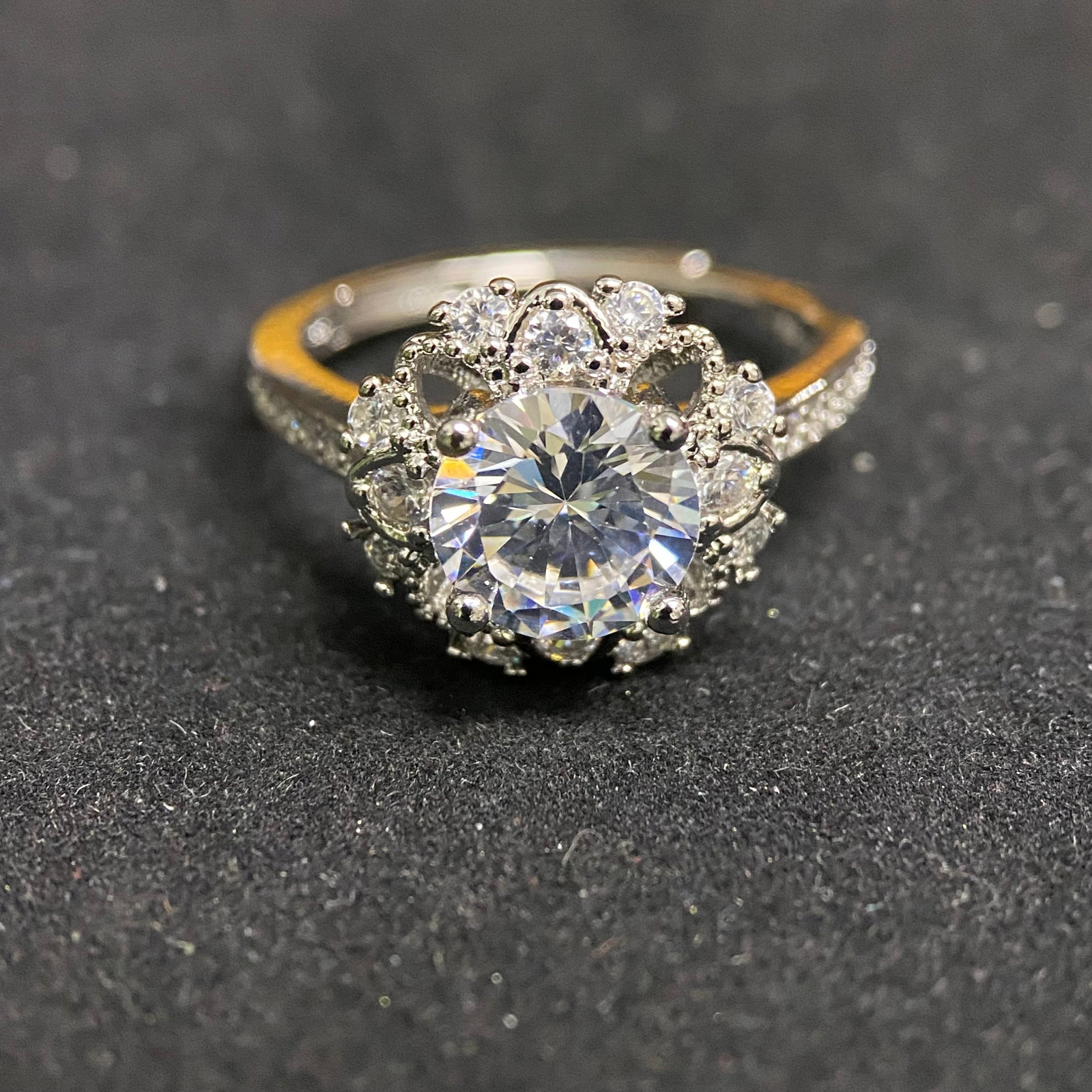 Round Brilliant Cut Scalloped Halo Ring: A sophisticated statement ring featuring a 2.0-carat round brilliant-cut center stone. The centerpiece is framed by a decorative scalloped halo set with shimmering accent stones, creating a vintage-in