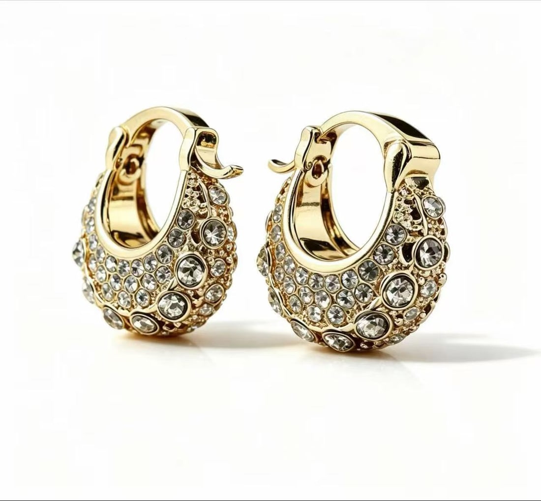 Moissanite Gilded Hoop Earrings: Pair of hoop earrings featuring moissanite accents in a rounded pavé-style design with gilded finish. Decorative contemporary style.