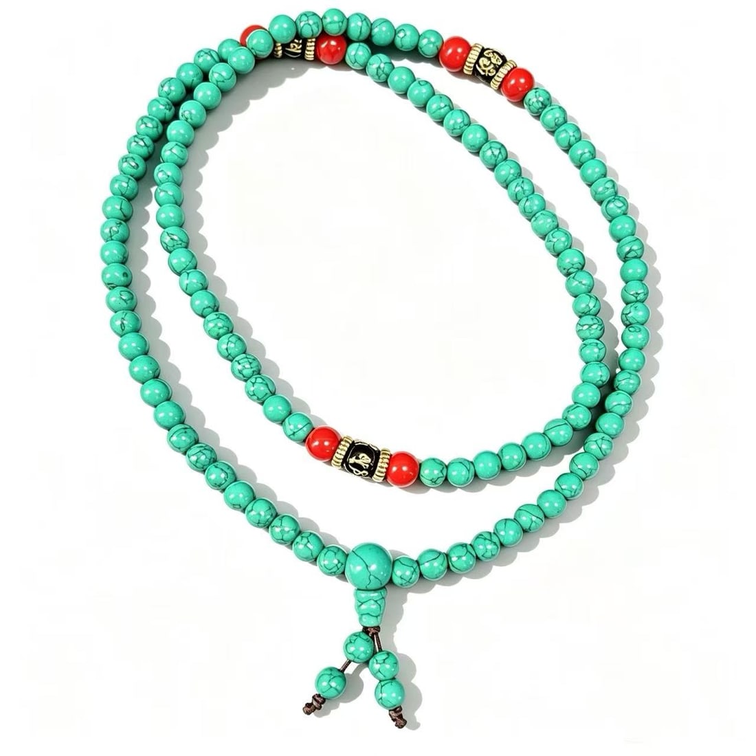 Turquoise Gold-Gilded Bead Necklace: Beaded necklace featuring turquoise beads accented with decorative gold-gilded elements and red accent beads. Ornamental multi-strand style design.